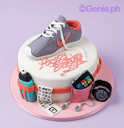 Running White Birthday Cake White fondant cake with a sculpted sneaker topper, race bib, water bottle, and sports watch decorations.