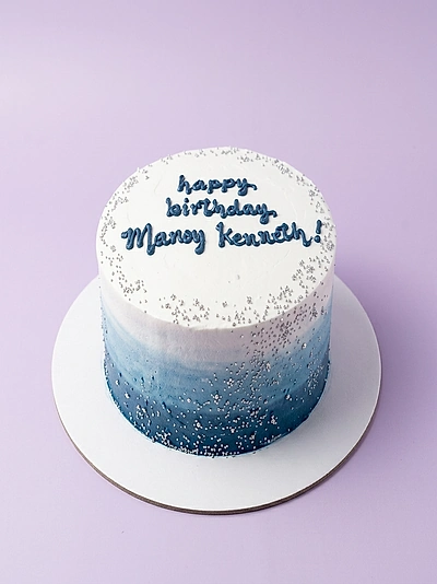 Silver cake theme design — 1 layer soft icing cake in White and Blue — with silver sprinkles, and custom "happy birthday Manoy Kennah!" message