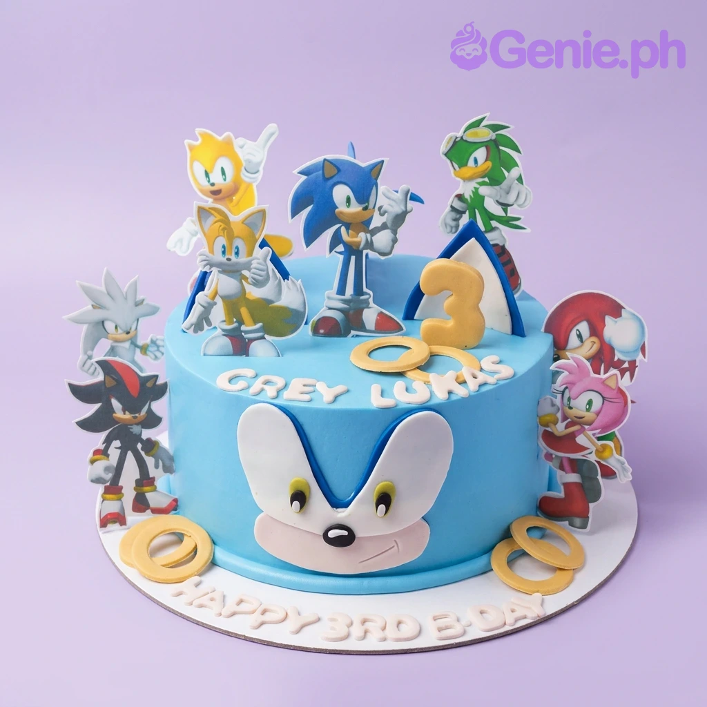 Sonic-Inspired The Hedgehog Blue Birthday Cake A blue 1-tier Sonic The Hedgehog cake with character printouts, a large Sonic face, a yellow number three, and yellow rings.