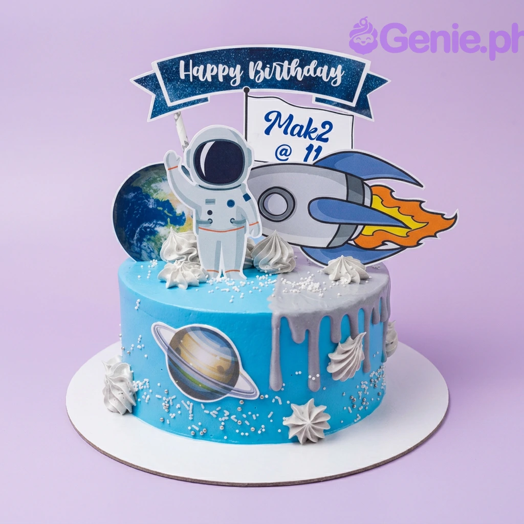 A blue and gray 1-tier Space Astronaut cake with an astronaut, rocket, planet cutouts, and silver sprinkles. A blue and gray 1-tier Space Astronaut cake with an astronaut, rocket, planet cutouts, and silver sprinkles.