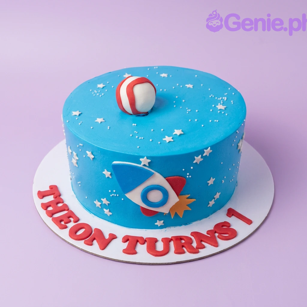 Space Rocket Blue Birthday Cake A blue, red, and white 1 Tier Space Rocket cake, featuring a 3D fondant rocket ship, a striped planet, white stars, and 'THEON TURNS 1' text.