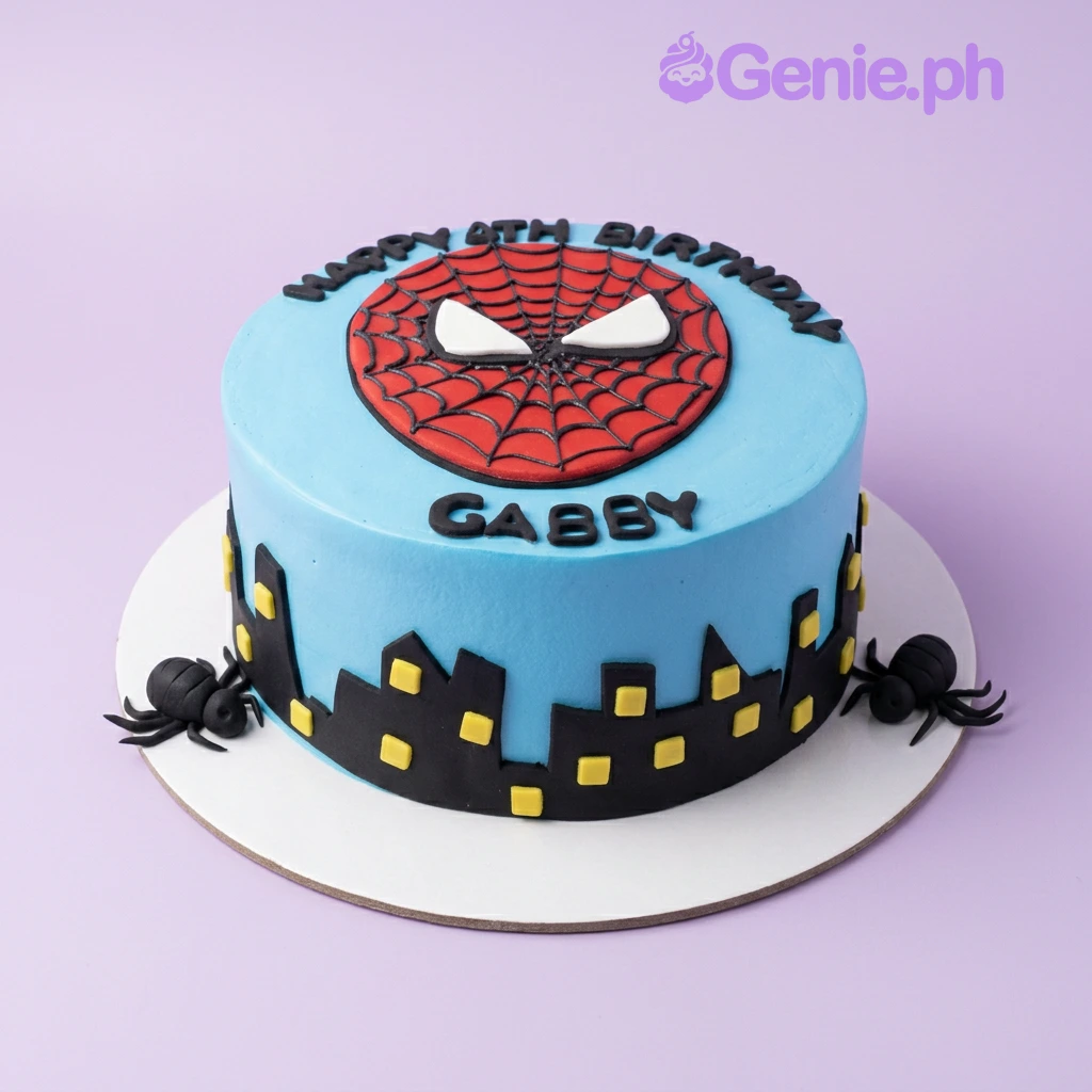 A blue 1 Tier Spiderman cake featuring a large red Spiderman face topper, black city skyline silhouette, and black spiders.