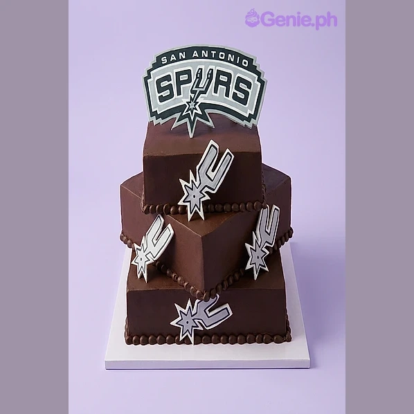 Spurs Basketball Brown 2-Tier Cake Brown 2-tier square cake with San Antonio Spurs logo printout topper and small logo cutouts on the sides