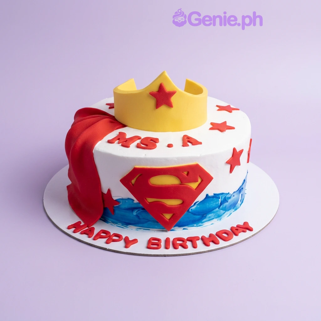 Superhero Crown Birthday Cake A colorful 1 Tier Superhero cake, featuring a yellow crown, red cape, Superman logo, red stars, and custom text.