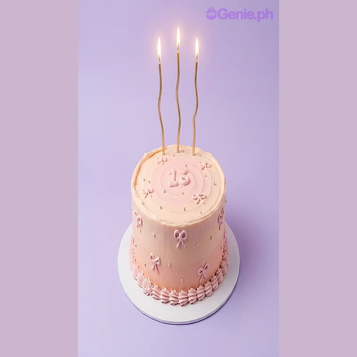 Sweet 16 Pink Birthday Cake Light pink single-tier cake with gold candles and number 16 topper