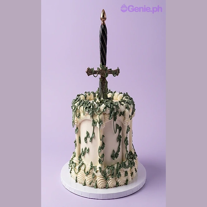 Sword White Birthday Cake White single-tier cake with green vines and a large sword topper