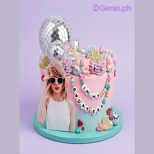 Taylor Swift Pink Glitter Birthday Cake Pink and blue gradient birthday cake with a Taylor Swift photo printout, disco ball toppers, and a beaded necklace message