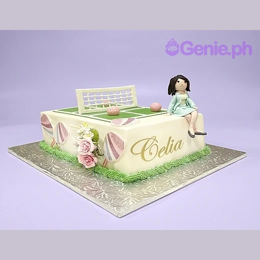 Tennis Birthday Ivory Rectangle Cake White rectangle cake with a tennis court design on top featuring a net and pink balls with a fondant girl figurine sitting on the edge