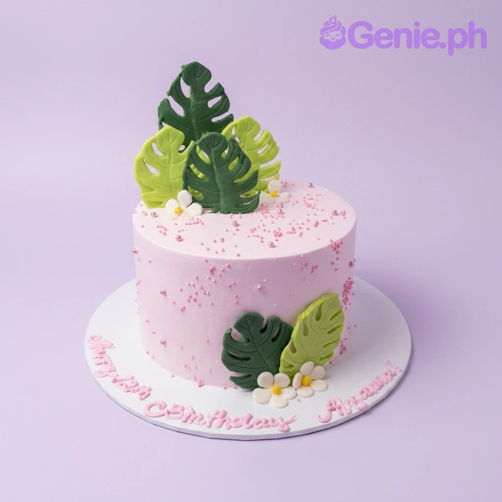 Tropical Monstera Pink Floral Birthday Cake A pink 1-Tier cake themed around Tropical Monstera, featuring green monstera leaves, white flowers, pink sprinkles, and silver dragees.