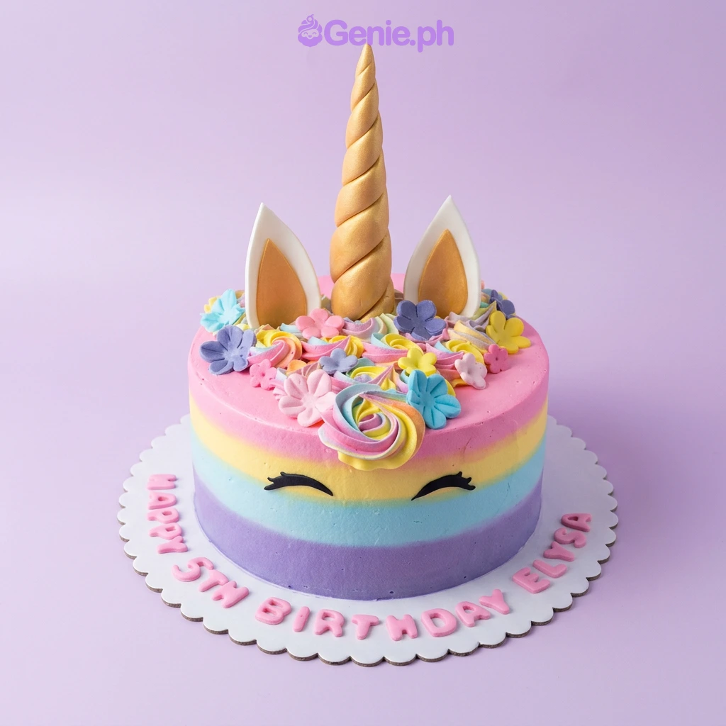 A pink and gold 1-Tier Unicorn cake, featuring a gold horn, ears, black eyelashes, multicolored rosettes, and 'Happy 5th Birthday Elysa' text.