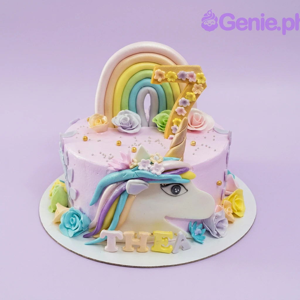 A pink 1-tier Unicorn cake, featuring a large pastel rainbow, a gold number 7, a unicorn face, and colorful fondant roses.