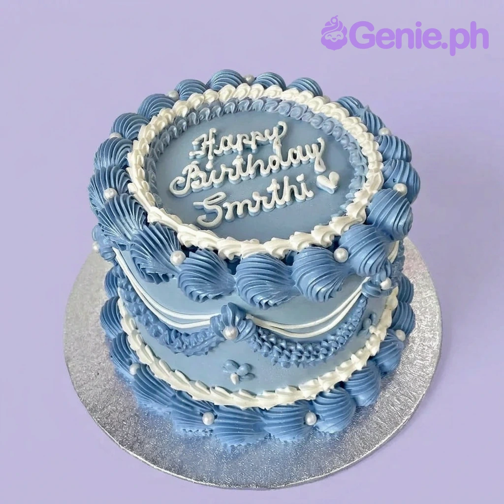 A light blue and white 1-tier cake themed Vintage Blue, with intricate piped shell borders, blue swags, and white edible pearls.