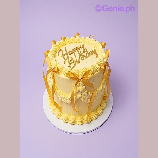 Yellow Birthday Ivory Cake Yellow 1-tier birthday cake with gold Happy Birthday topper and yellow satin ribbons