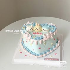 Bunny Heart Sky Blue Birthday Cake Light blue heart-shaped cake with three cute bunny figurines and 100 message on top