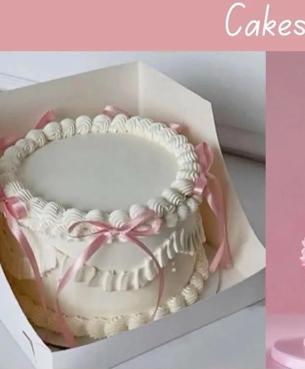 White minimalist cake with pink ribbon bows and piped icing ruffles in a white box