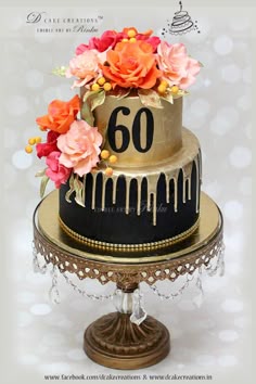 Elegant two-tier black and gold 60th birthday cake with vibrant orange and pink sugar roses and a gold drip effect. Elegant two-tier black and gold 60th birthday cake with vibrant orange and pink sugar roses and a gold drip effect.