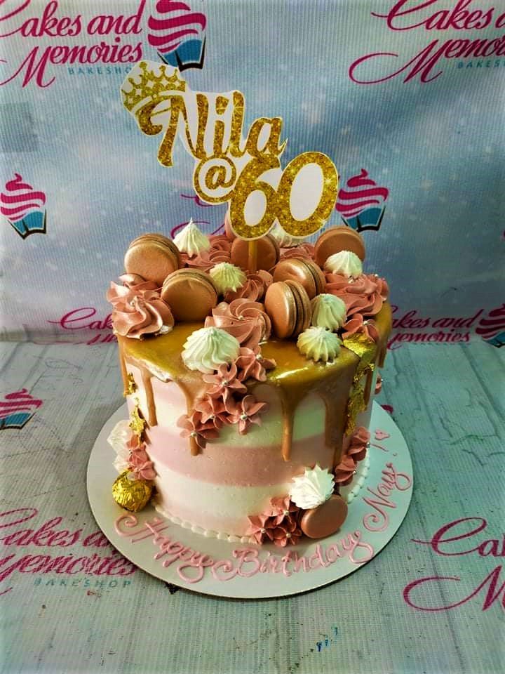 Pink and white striped birthday cake with gold drip, macarons, and a gold glitter Nila @ 60 topper. Pink and white striped birthday cake with gold drip, macarons, and a gold glitter Nila @ 60 topper.