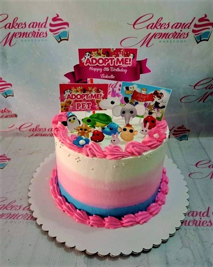Adopt Me themed birthday cake with pink, white, and blue gradient icing, pink rosettes, and various character printouts. Adopt Me themed birthday cake with pink, white, and blue gradient icing, pink rosettes, and various character printouts.