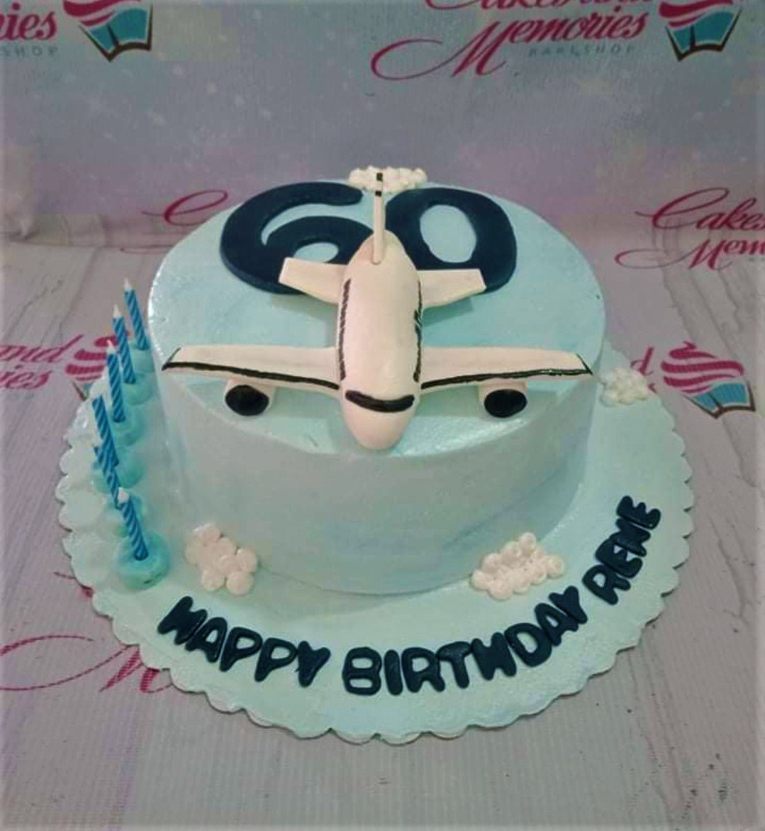 Light blue airplane themed birthday cake for a 60th birthday with a 3D fondant plane and clouds. Light blue airplane themed birthday cake for a 60th birthday with a 3D fondant plane and clouds.