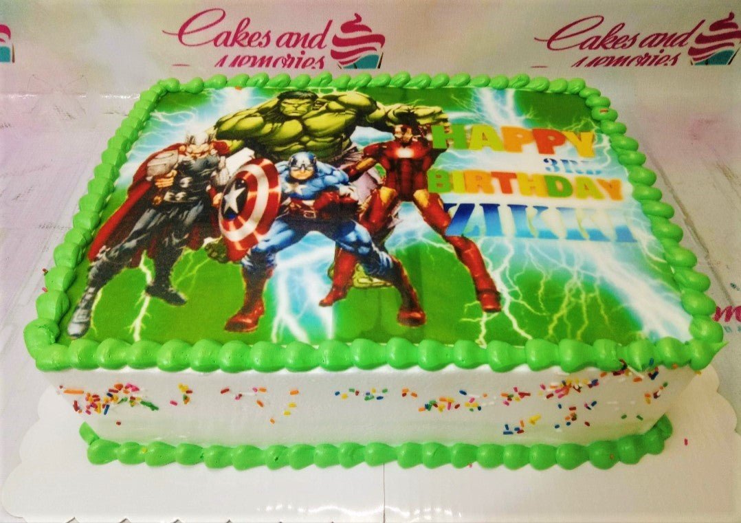 Avengers themed rectangle birthday cake with Hulk, Thor, Captain America, and Iron Man edible photo print and green icing borders. Avengers themed rectangle birthday cake with Hulk, Thor, Captain America, and Iron Man edible photo print and green icing borders.
