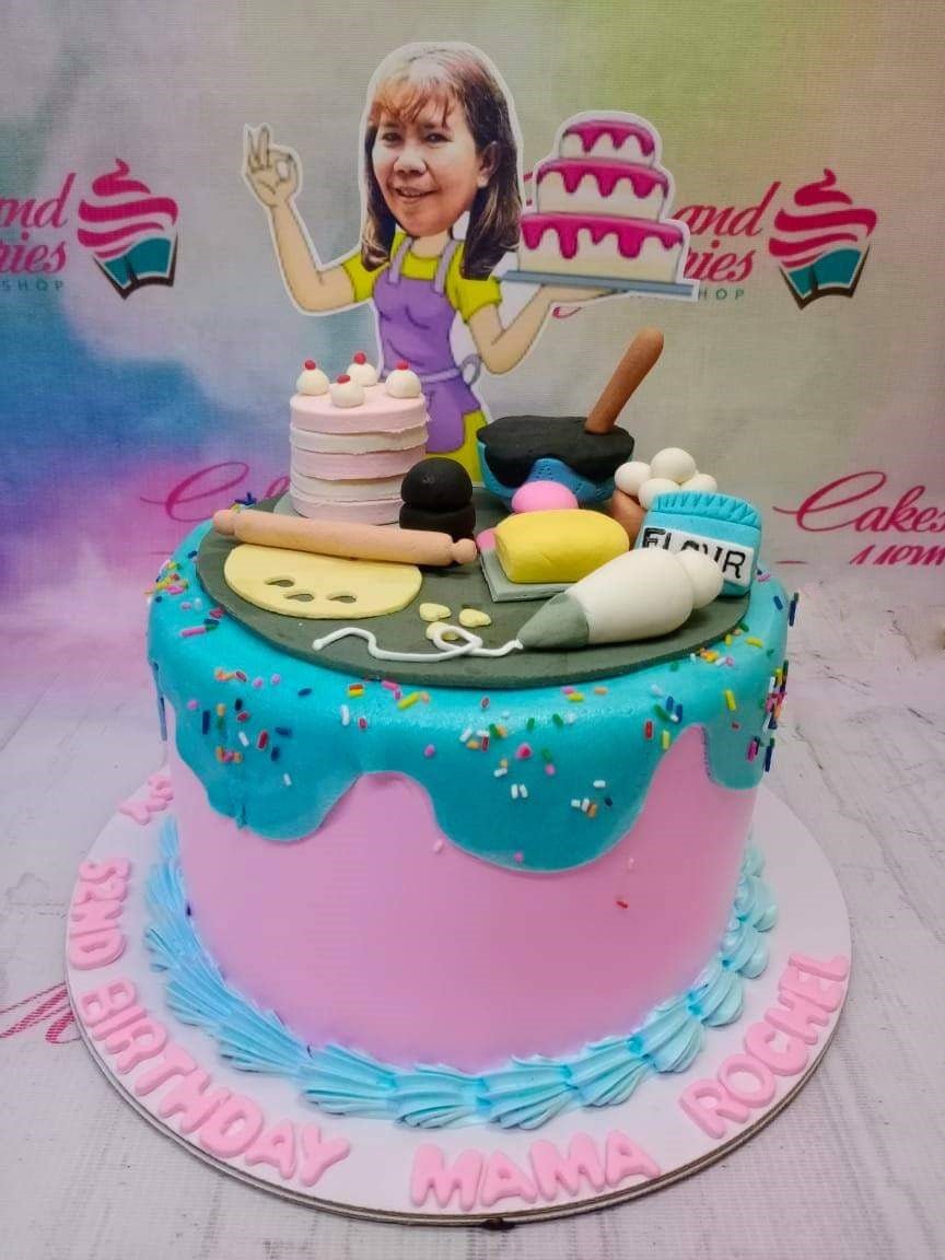 Pink and teal baker themed birthday cake with a custom caricature topper and fondant baking tools. Pink and teal baker themed birthday cake with a custom caricature topper and fondant baking tools.