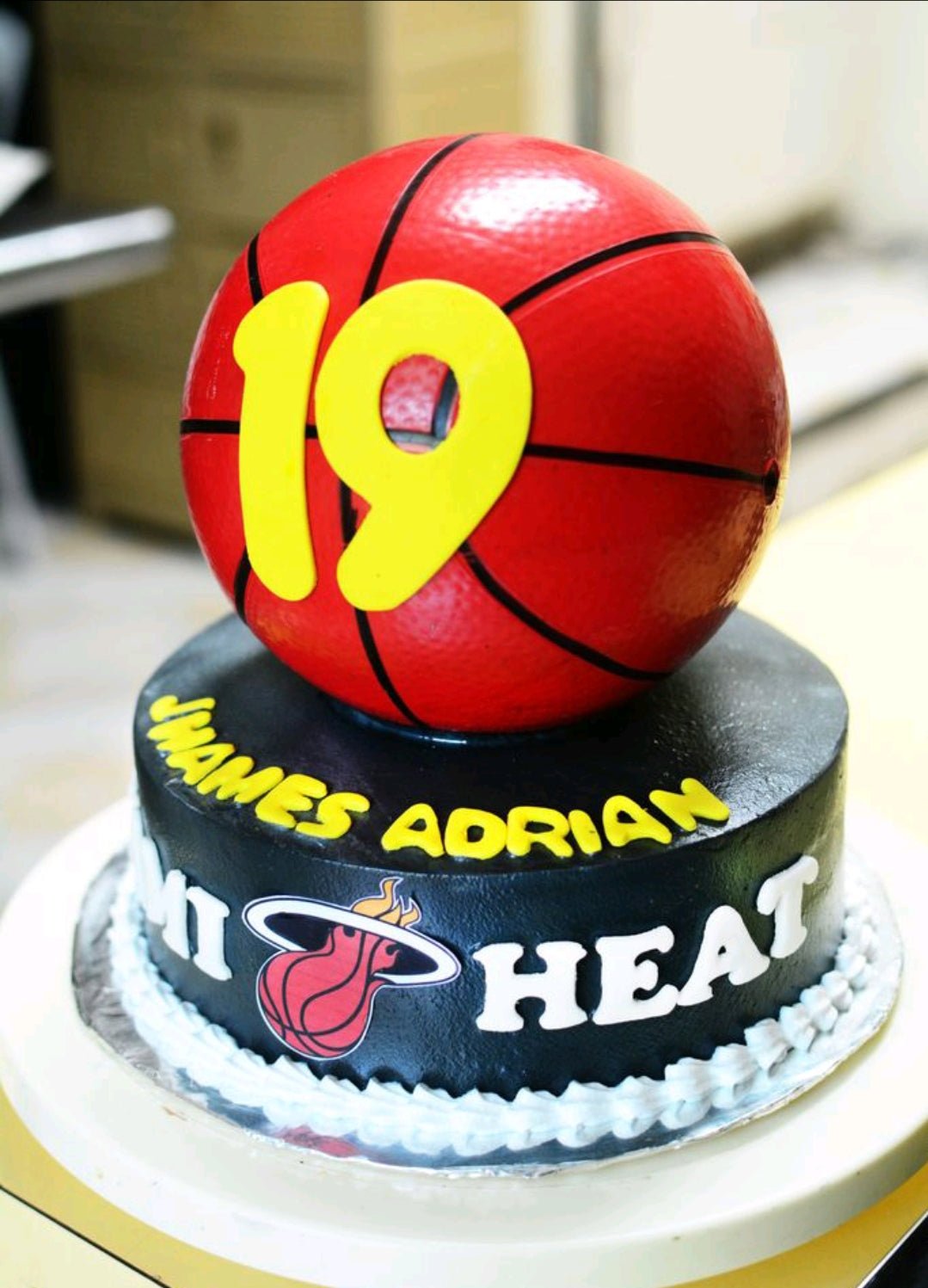 Miami Heat basketball themed cake with a large 3D basketball topper and yellow number 19. Miami Heat basketball themed cake with a large 3D basketball topper and yellow number 19.