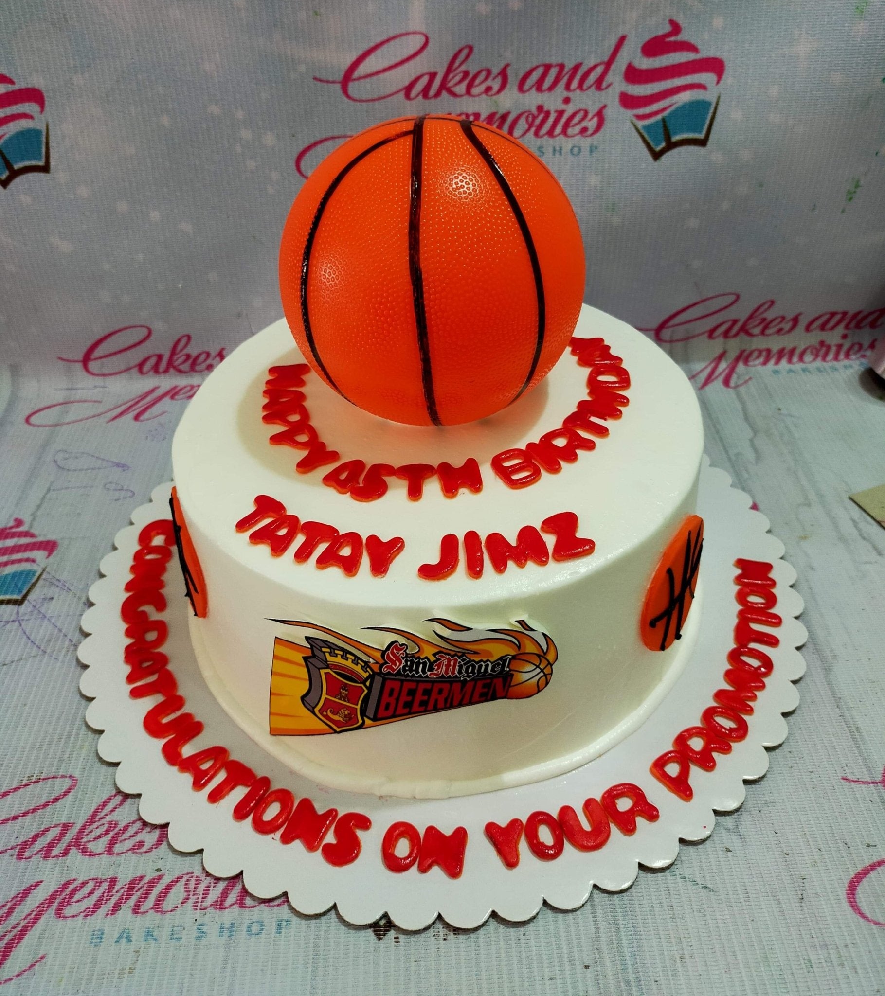 White basketball themed cake with a large orange basketball topper and San Miguel Beermen logo for a 45th birthday and promotion. White basketball themed cake with a large orange basketball topper and San Miguel Beermen logo for a 45th birthday and promotion.