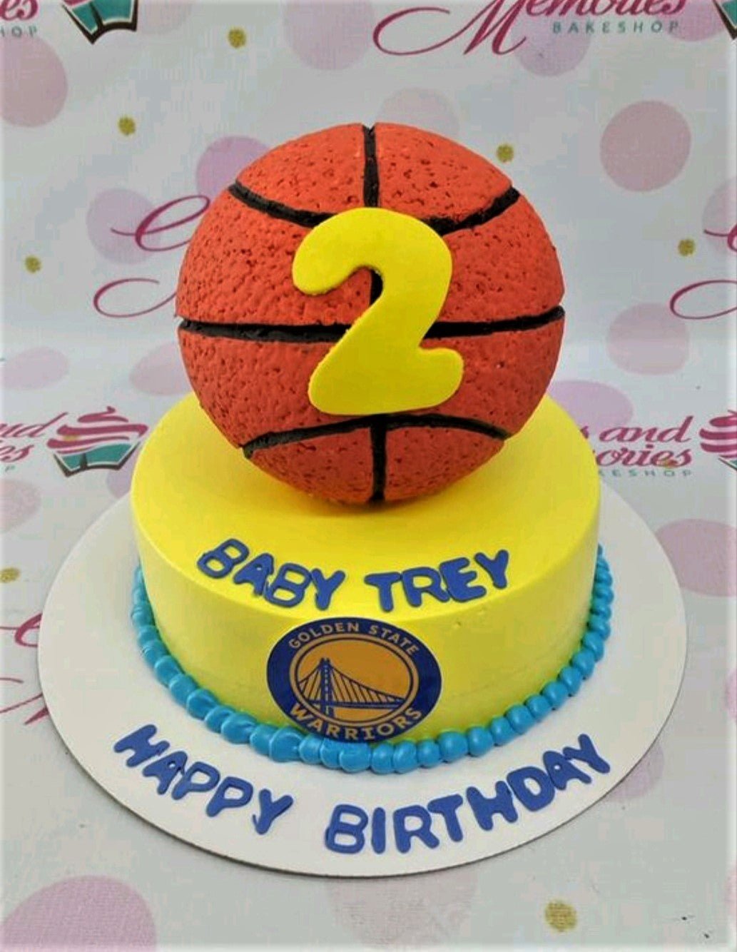 Yellow Golden State Warriors basketball themed birthday cake with a large 3D basketball topper and blue icing border. Yellow Golden State Warriors basketball themed birthday cake with a large 3D basketball topper and blue icing border.