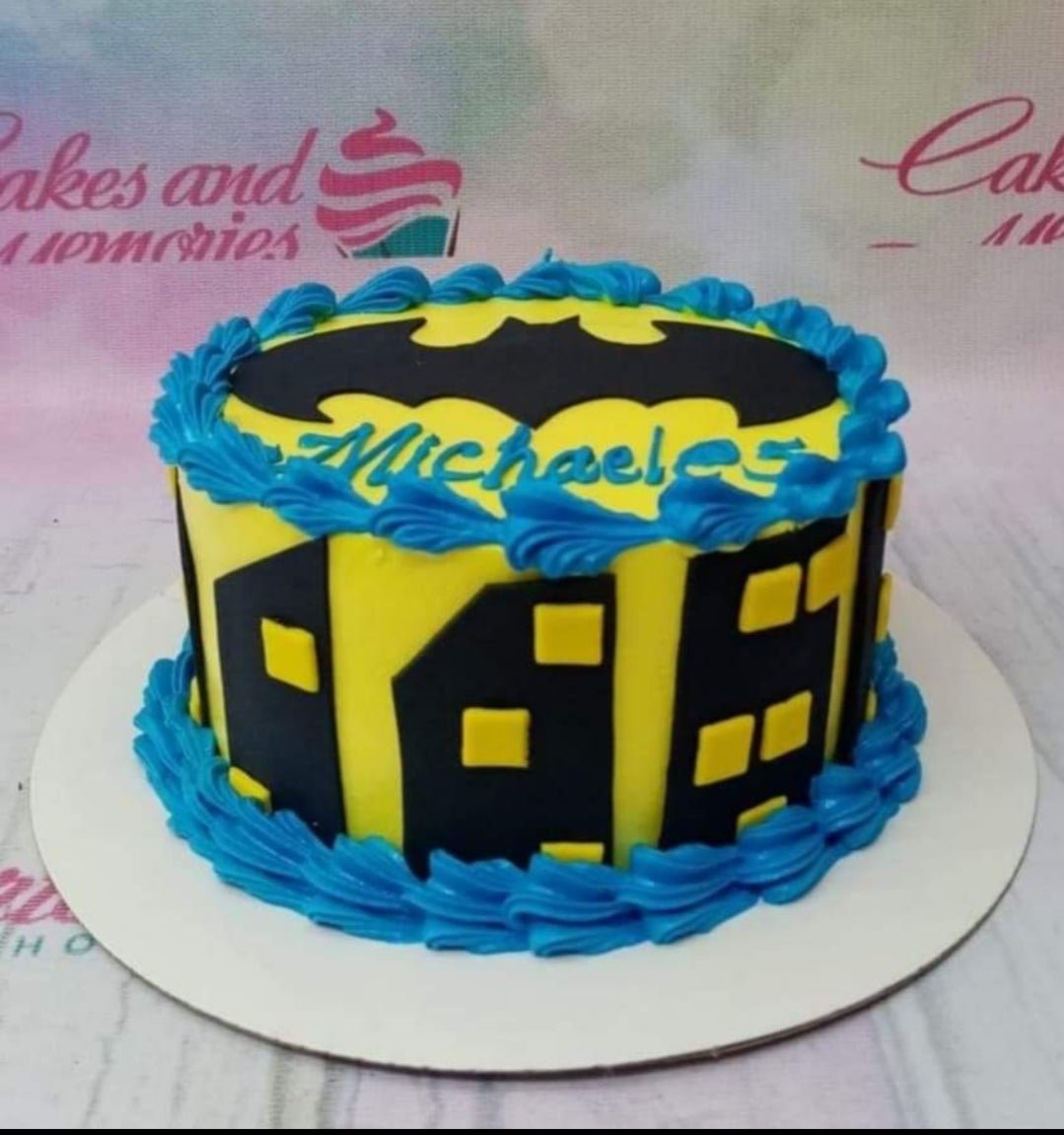 Batman themed yellow cake with black city skyline silhouettes and blue icing borders Batman themed yellow cake with black city skyline silhouettes and blue icing borders