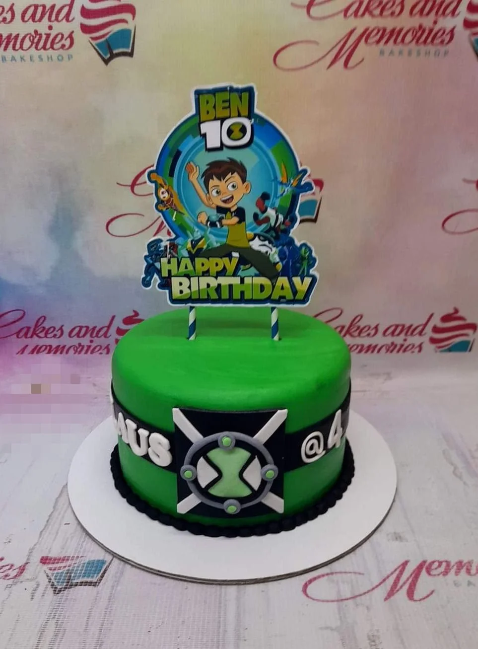 Ben 10 Green Birthday Cake Green Ben 10 themed birthday cake with a large character printout topper and a black fondant band featuring the Omnitrix symbol.