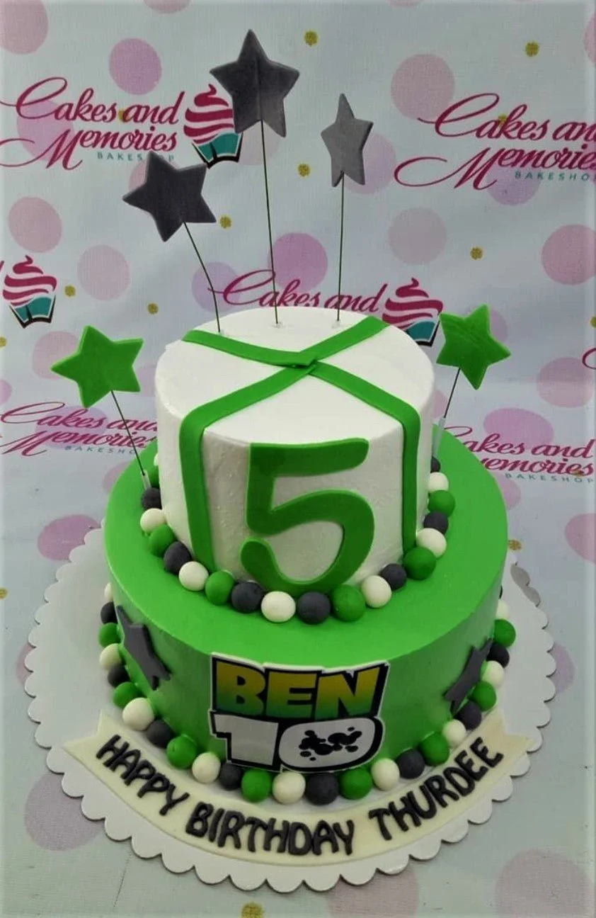 Ben 10 2-Tier Birthday Cake Two-tier Ben 10 themed birthday cake with green and white icing, fondant stars, and a large number 5 topper.