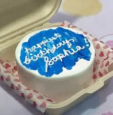 Bento birthday blue cake design — bento soft icing cake in white — with blue icing spread, and custom "happiest birthday Sophia" message