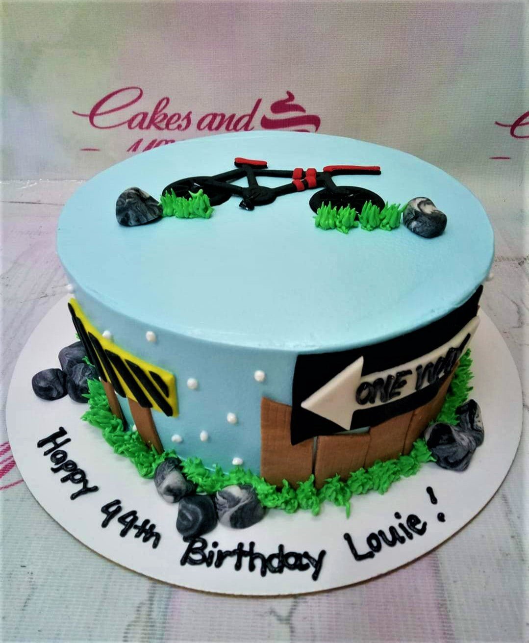 Light blue bicycle themed birthday cake with fondant rocks, grass, and road signs for Louie's 44th birthday. Light blue bicycle themed birthday cake with fondant rocks, grass, and road signs for Louie's 44th birthday.