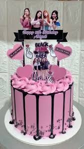 Pink Blackpink themed birthday cake with black chocolate drip, pink icing rosettes, and character printouts of the K-pop group. Pink Blackpink themed birthday cake with black chocolate drip, pink icing rosettes, and character printouts of the K-pop group.