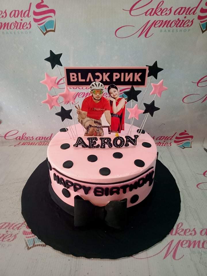 Pink Blackpink themed birthday cake with a cyclist and Jennie printouts, black polka dots, and star toppers. Pink Blackpink themed birthday cake with a cyclist and Jennie printouts, black polka dots, and star toppers.