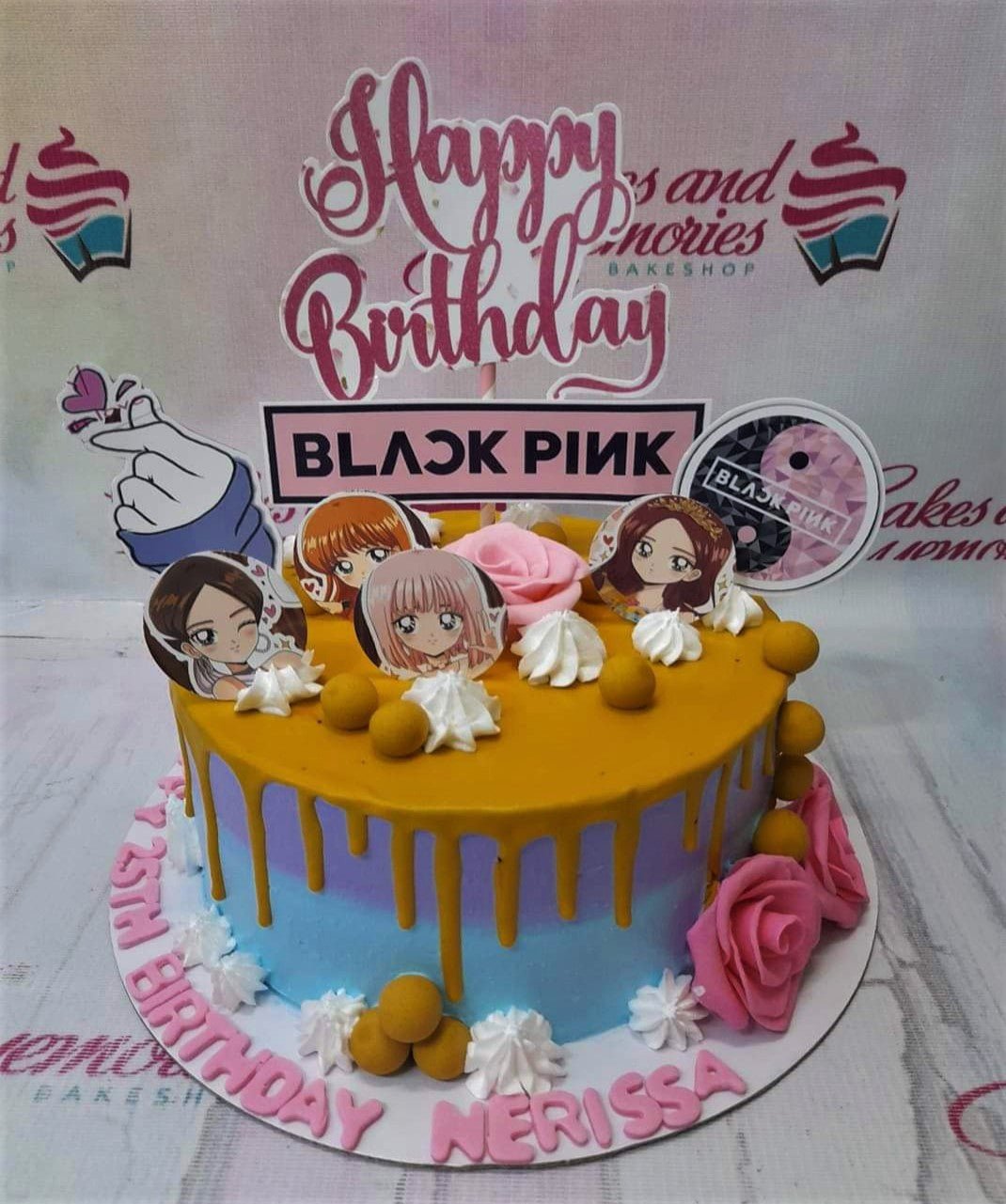 Blackpink themed birthday cake with blue and purple gradient icing, yellow drip, and character printouts. Blackpink themed birthday cake with blue and purple gradient icing, yellow drip, and character printouts.