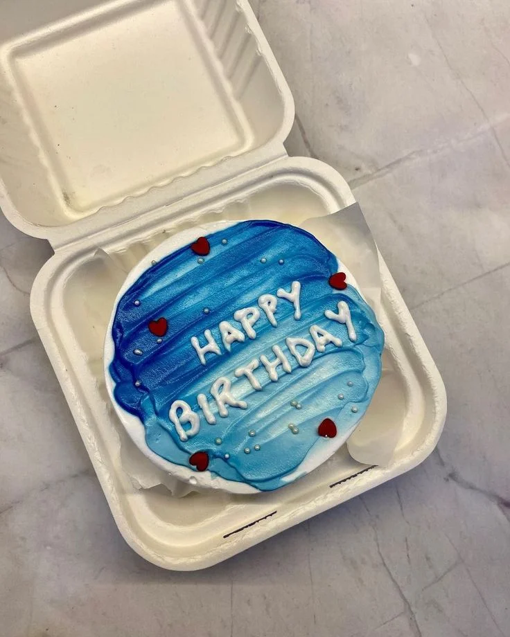 Blue and white bento cake with a textured palette knife finish, red hearts, silver pearls, and a Happy Birthday message. Blue and white bento cake with a textured palette knife finish, red hearts, silver pearls, and a Happy Birthday message.