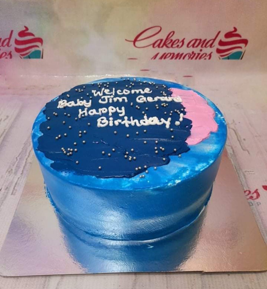 Blue minimalist birthday cake with a dark blue palette knife icing top, pink accent, and silver dragees. Blue minimalist birthday cake with a dark blue palette knife icing top, pink accent, and silver dragees.