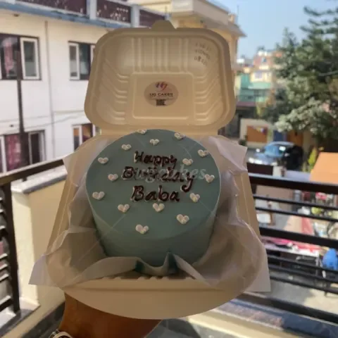 Light blue bento cake with white icing hearts and a Happy Birthday Baba message in dark brown icing. Light blue bento cake with white icing hearts and a Happy Birthday Baba message in dark brown icing.