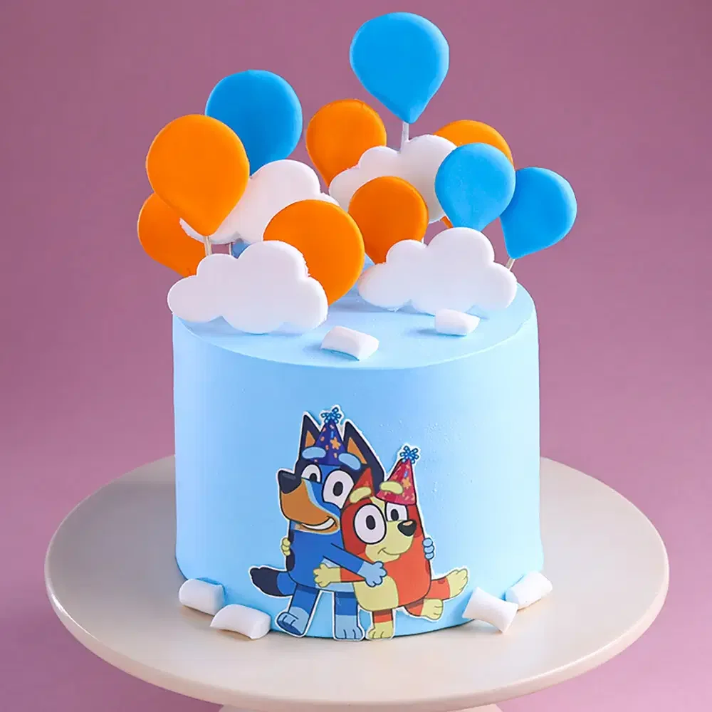 Light blue Bluey themed birthday cake with fondant clouds and colorful balloon toppers Light blue Bluey themed birthday cake with fondant clouds and colorful balloon toppers