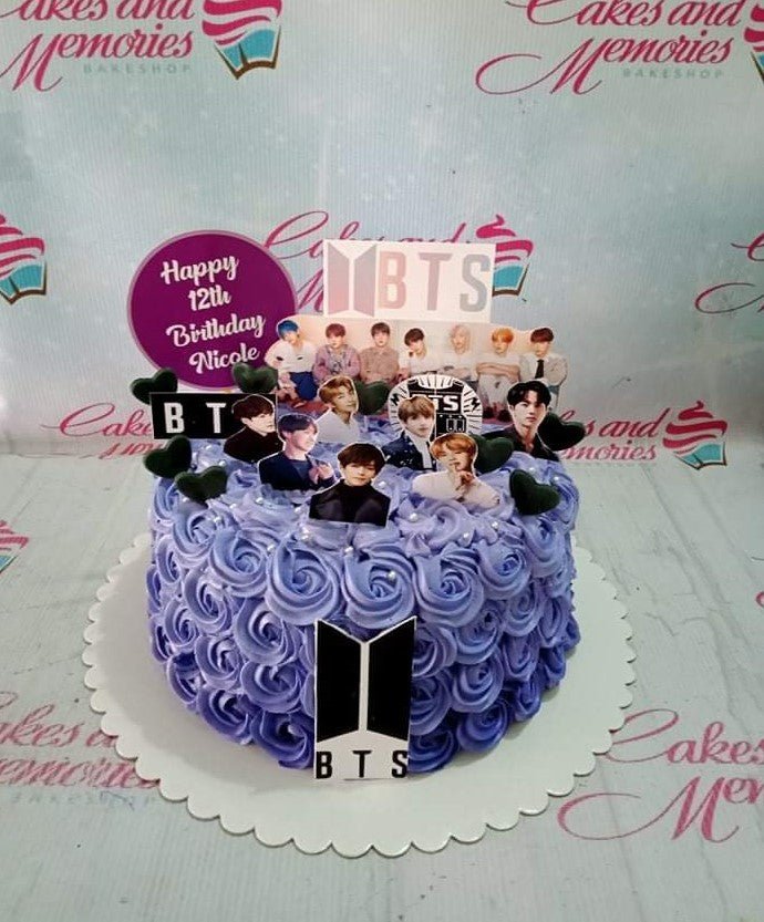 Purple BTS themed birthday cake with lavender icing rosettes and K-pop member printout toppers. Purple BTS themed birthday cake with lavender icing rosettes and K-pop member printout toppers.