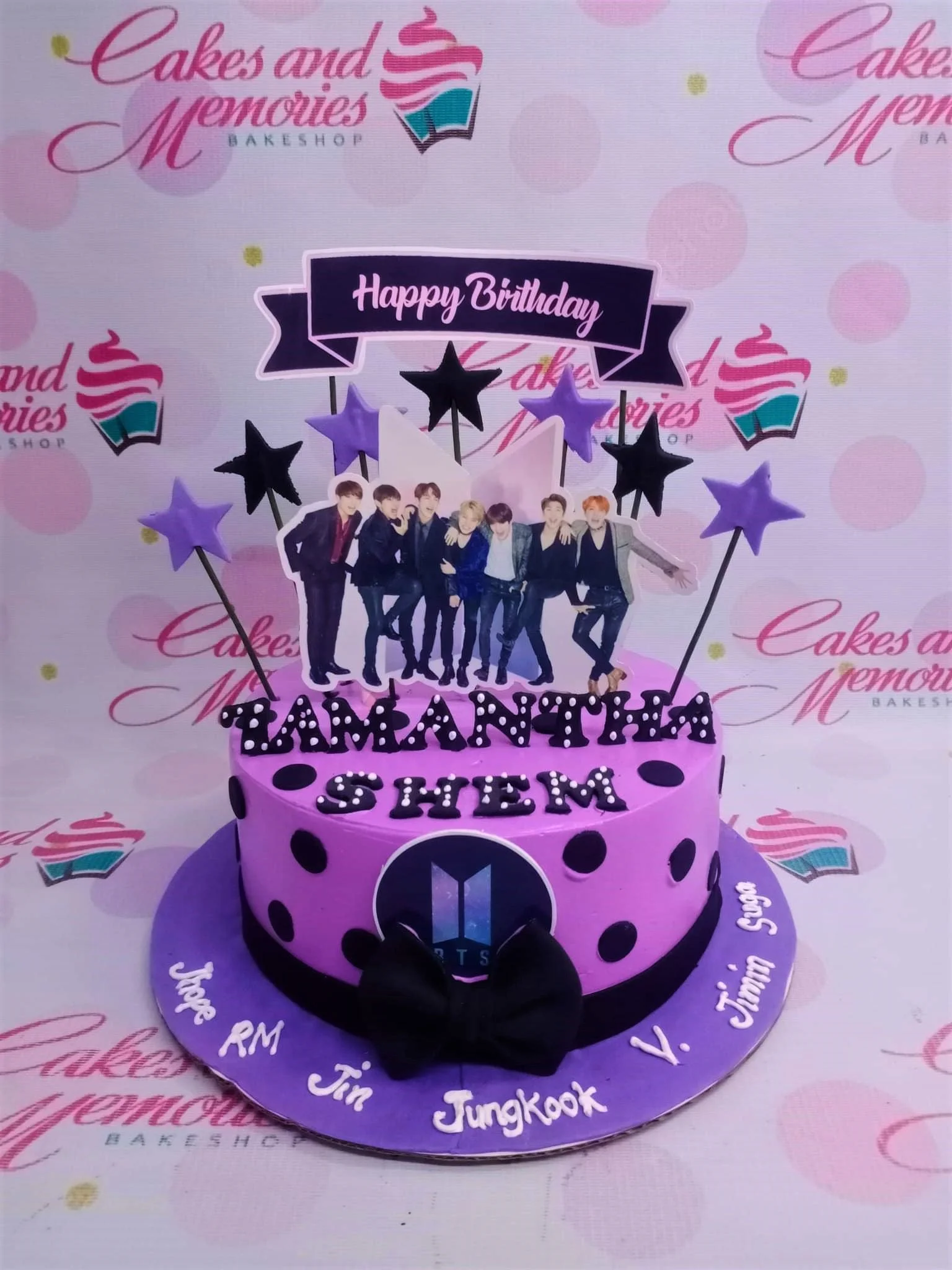 BTS Kpop-Inspired Purple Bow Birthday Cake Purple BTS themed birthday cake with group photo printout, black polka dots, and a black fondant bow.