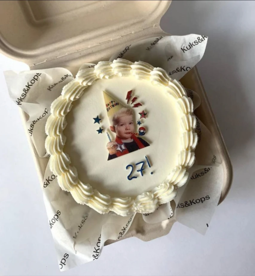 White bento cake with a custom photo print of a child and blue piped age message