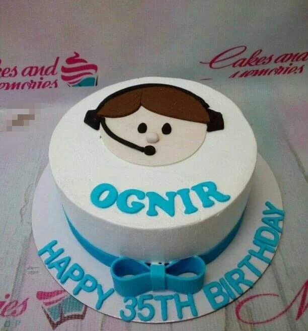 A white and blue 1-tier round Call Center Agent cake, with a fondant agent face topper, blue ribbon, and blue lettering.