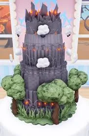 Tall grey castle-themed cake with green gumpaste trees, white clouds, and orange flame accents. Tall grey castle-themed cake with green gumpaste trees, white clouds, and orange flame accents.