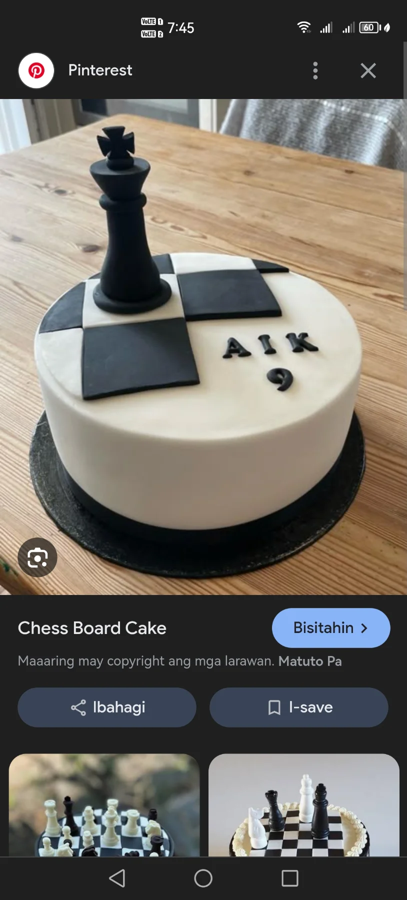 White fondant cake with black and white chess board tiles and a large black fondant king chess piece topper. White fondant cake with black and white chess board tiles and a large black fondant king chess piece topper.
