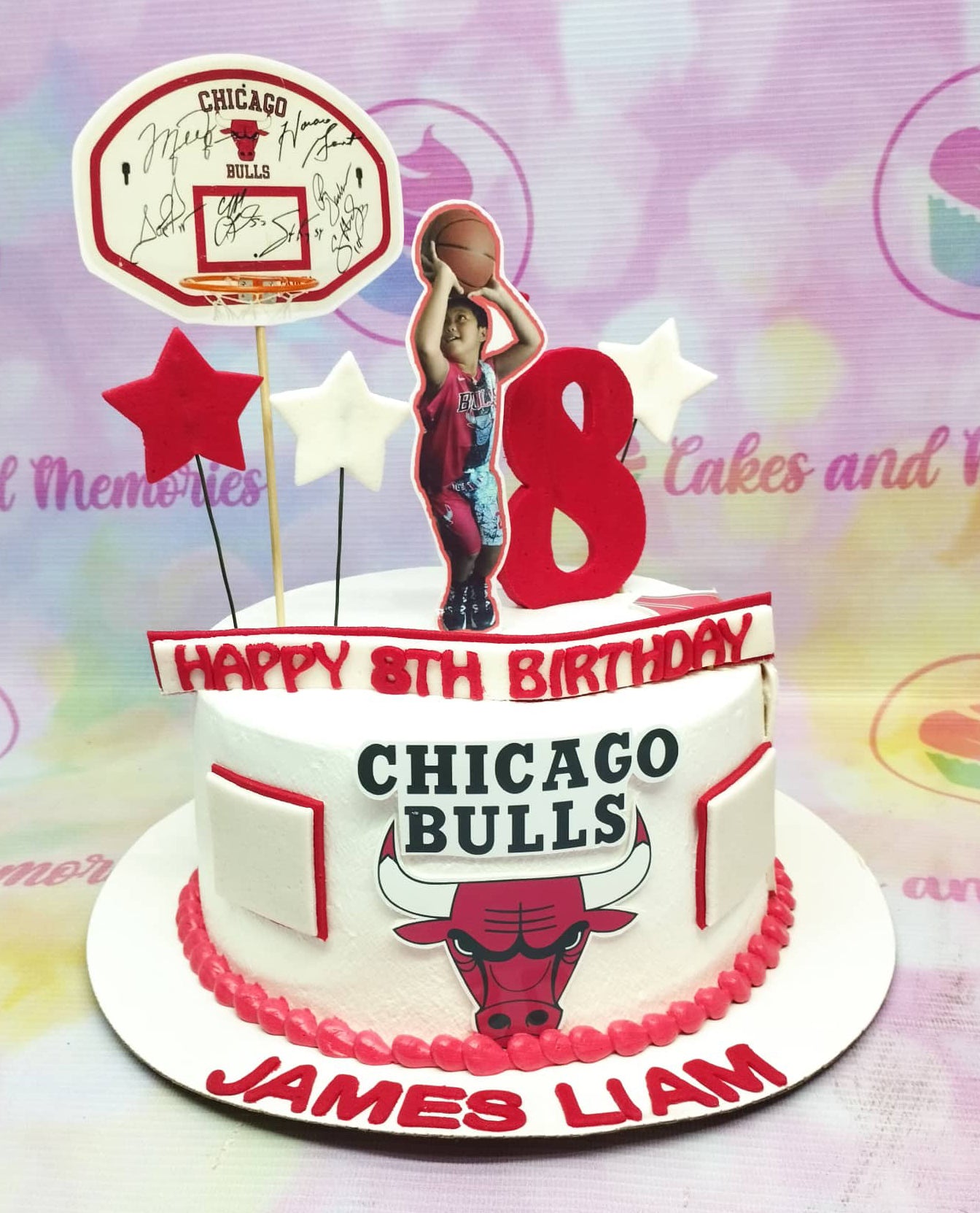 Chicago Bulls basketball themed birthday cake with a photo printout of a boy shooting a basketball and a large red number 8 topper. Chicago Bulls basketball themed birthday cake with a photo printout of a boy shooting a basketball and a large red number 8 topper.