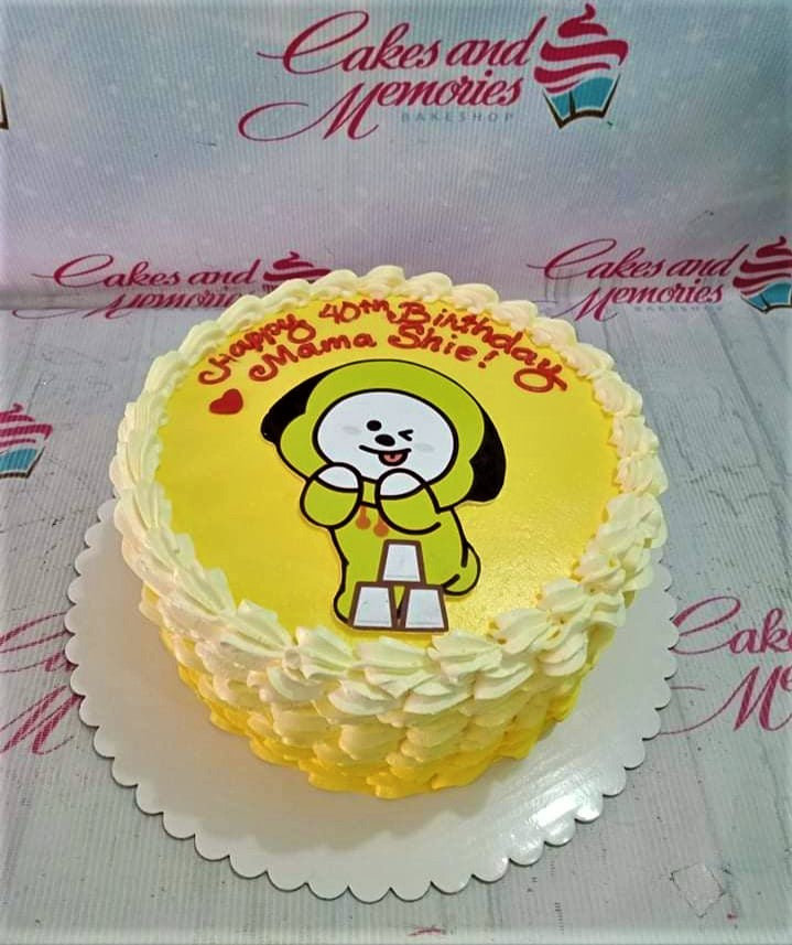 Yellow Chimmy BT21 character cake with white icing rosettes and a red heart for a 40th birthday celebration. Yellow Chimmy BT21 character cake with white icing rosettes and a red heart for a 40th birthday celebration.