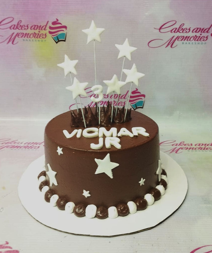 Chocolate brown birthday cake with white fondant stars and white gumpaste letters for Vicmar Jr. Chocolate brown birthday cake with white fondant stars and white gumpaste letters for Vicmar Jr.