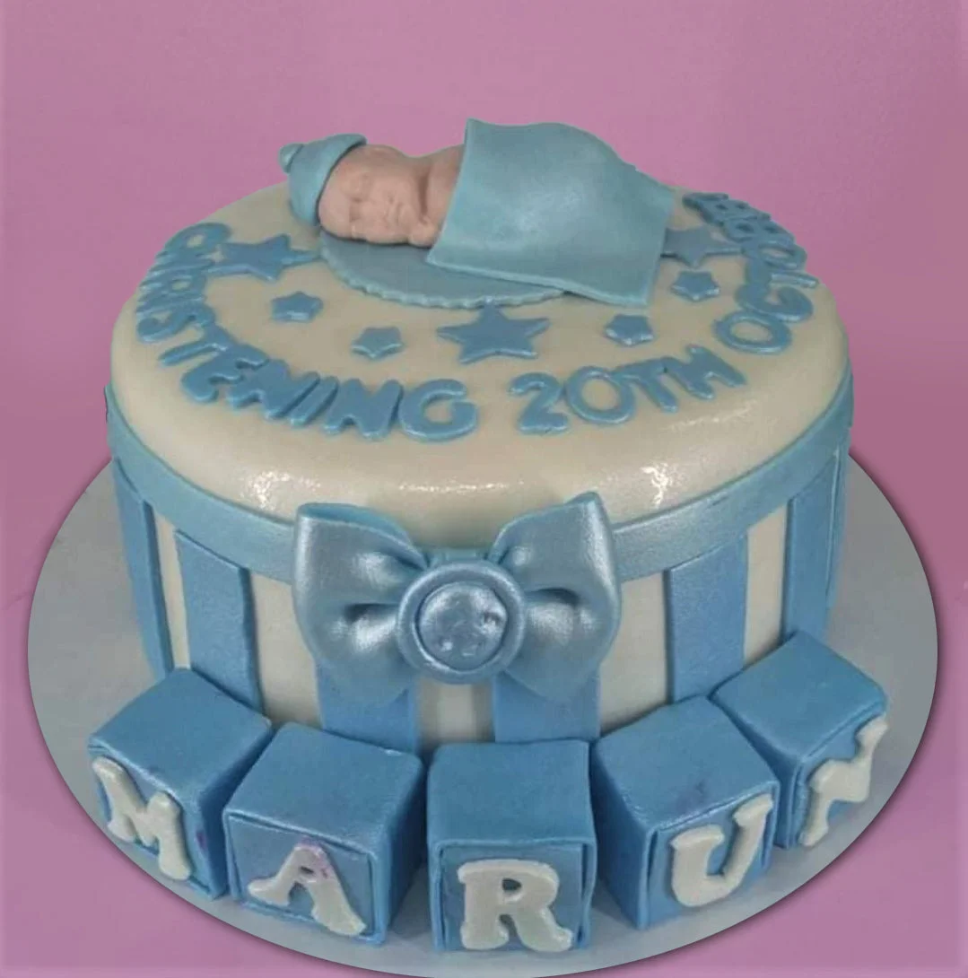 Christening Cake Blue and white fondant christening cake with a sleeping baby topper, stars, and name blocks.